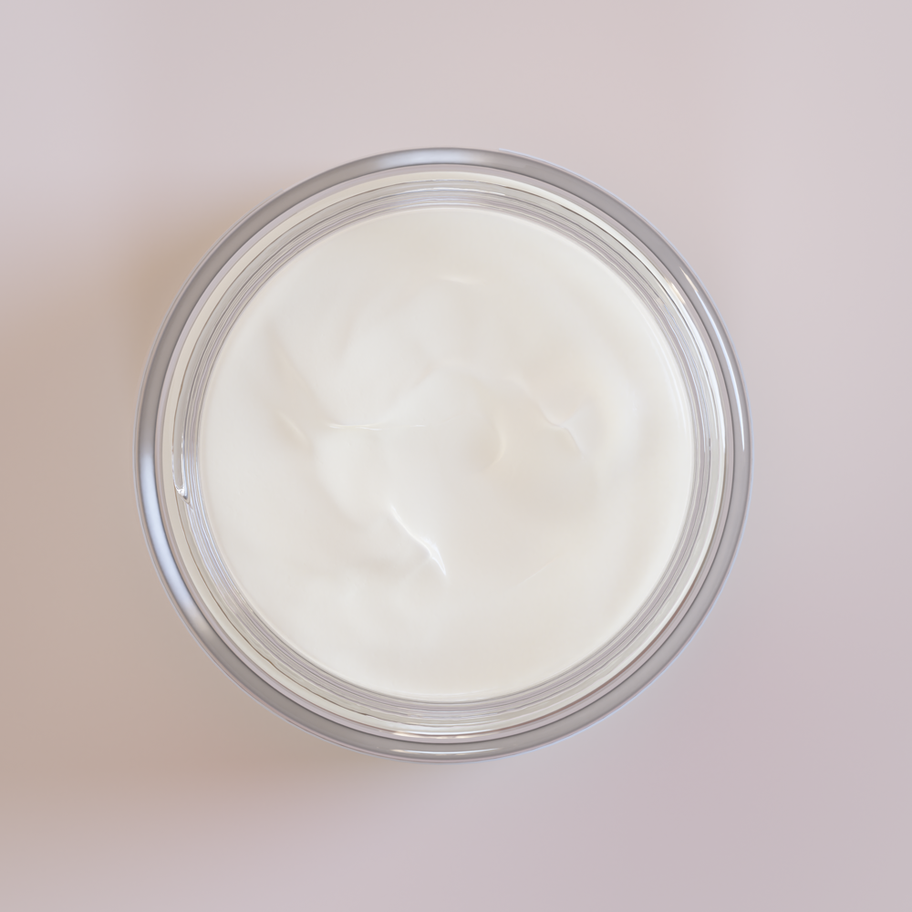Top-down view of an open glass jar filled with smooth white cream next to an about us section text block