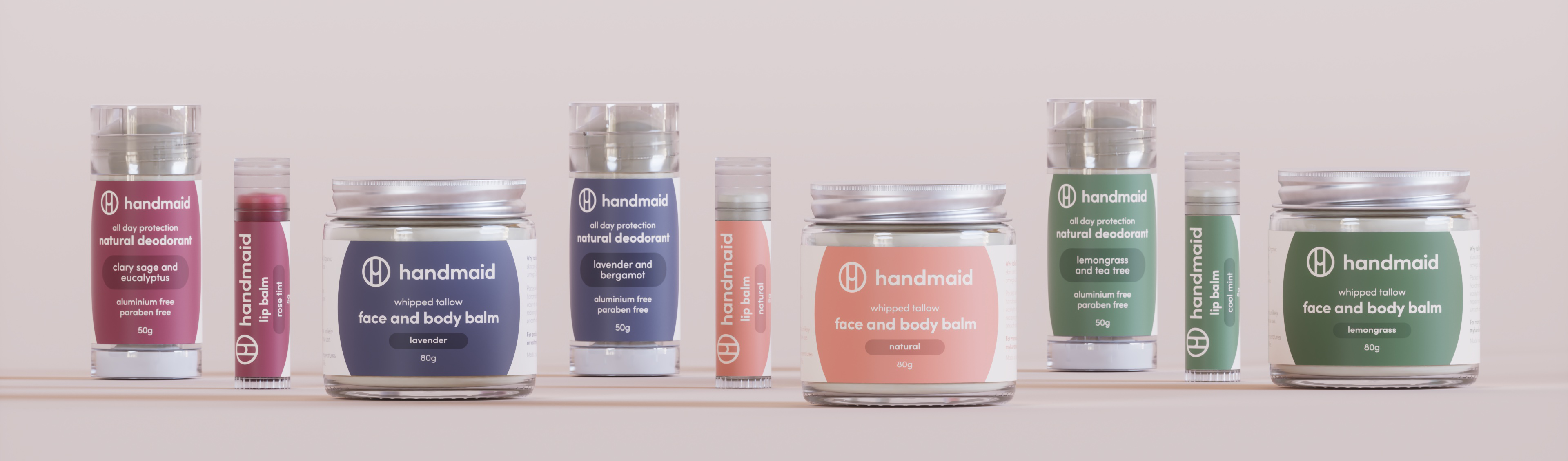 A wide product lineup banner for myhandmaid featuring natural deodorants, lip balms, and jars of whipped tallow face and body balm arranged neatly in various scents including clary sage, lavender, lemongrass, and mint.